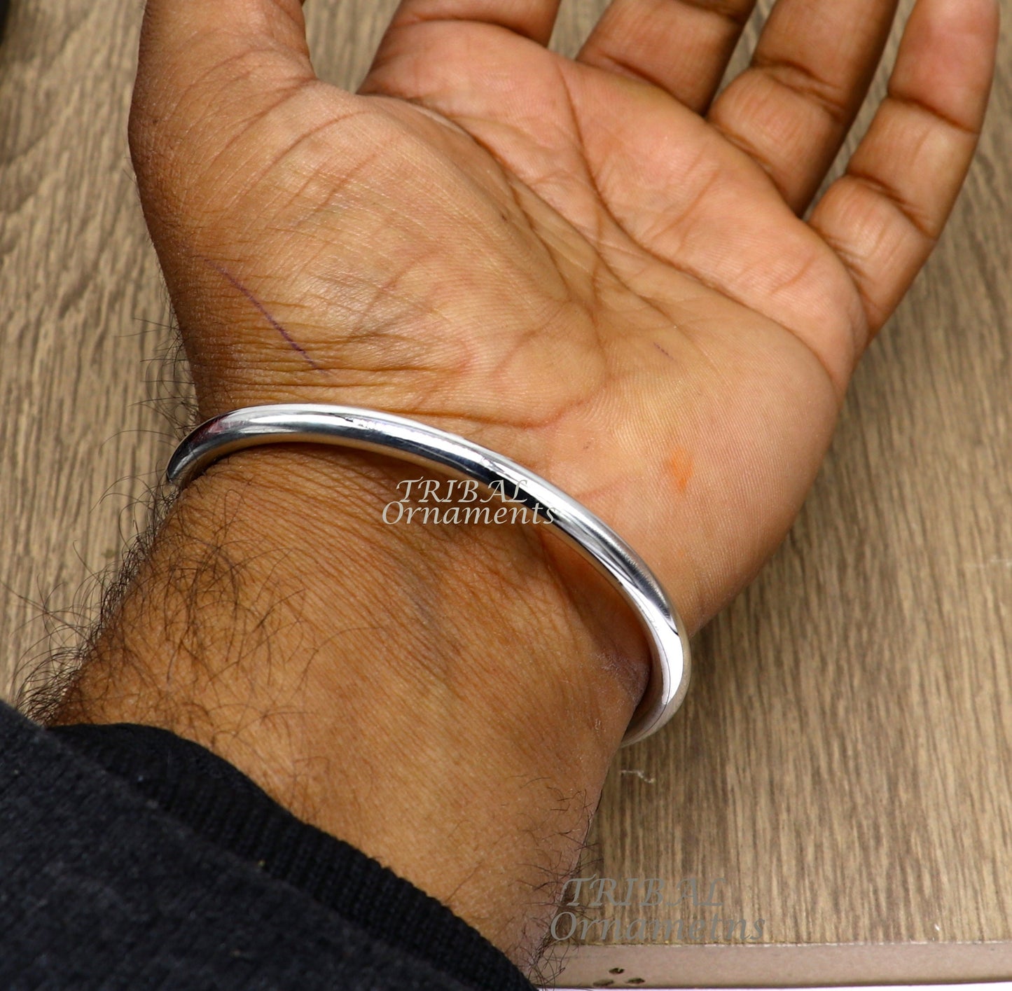 Sterling silver handmade bangle bracelet by TRIBAL ORNAMENTS, shiny, plain, customized unisex jewelry for gifting or everyday wear.