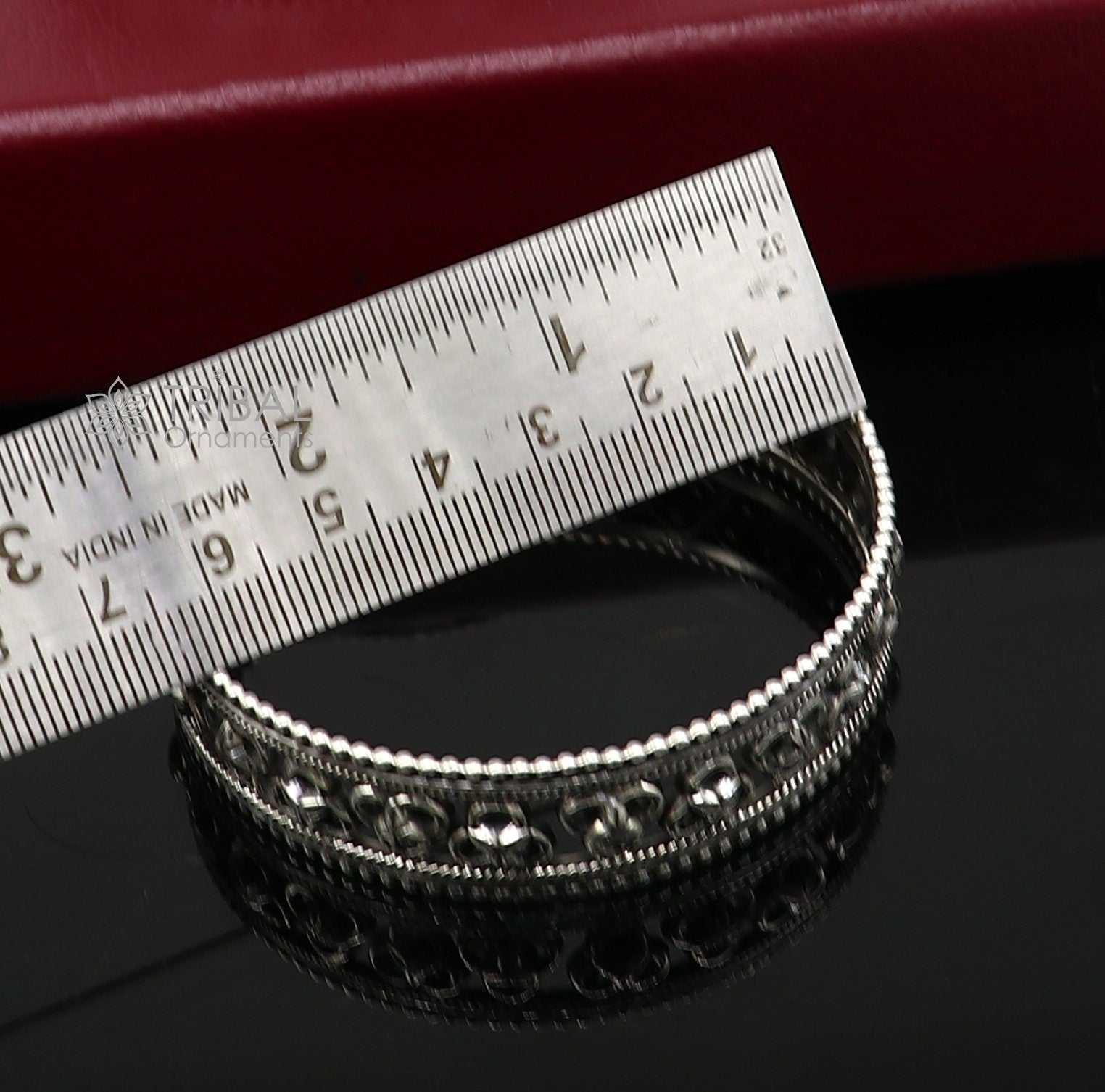 Sterling silver tribal bangle bracelet with cultural design from TRIBAL ORNAMENTS, featuring intricate tribal jewelry patterns.