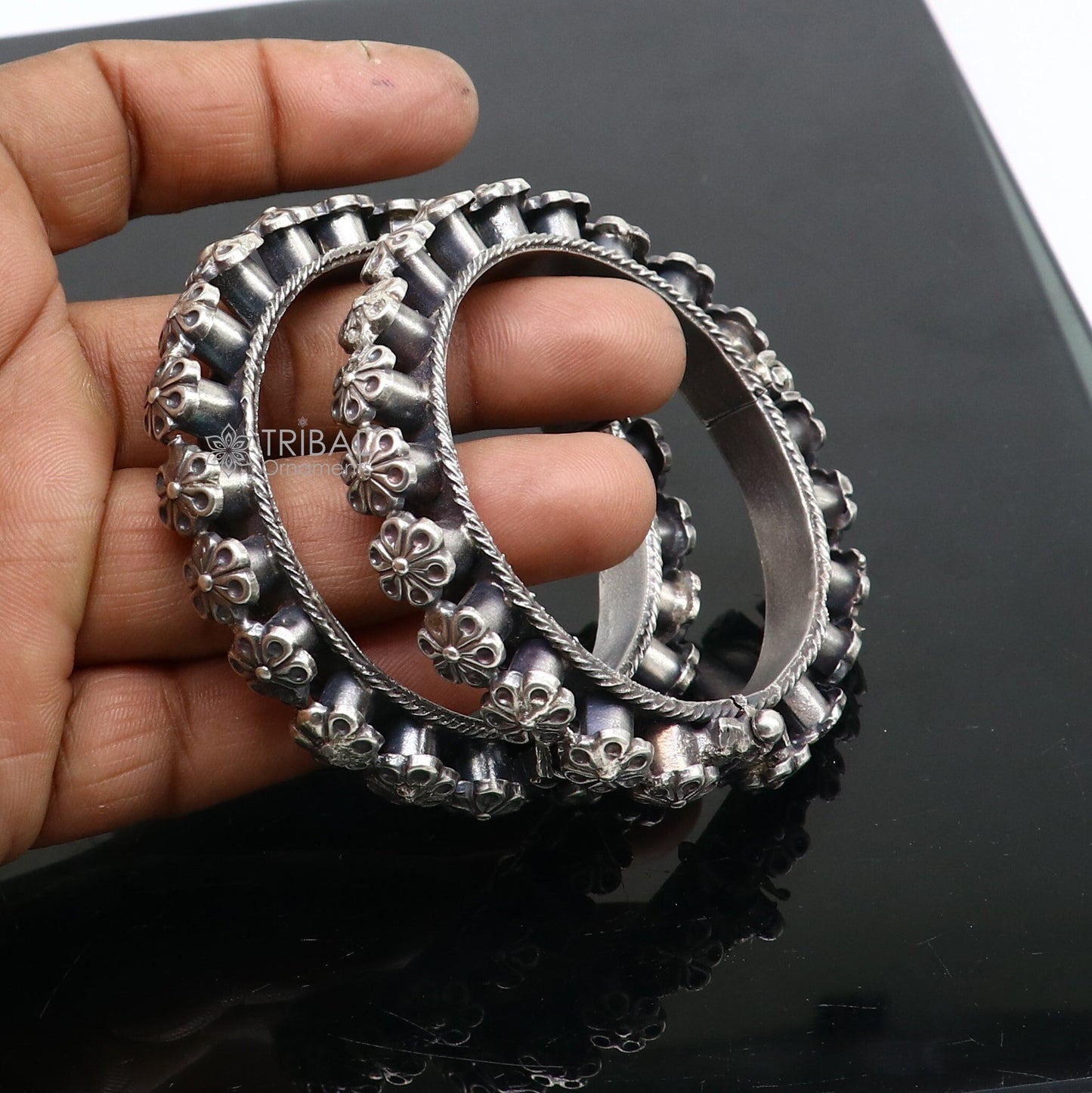 Sterling silver tribal floral bangle bracelet by TRIBAL ORNAMENTS, featuring intricate tribal design for wedding or cultural attire.