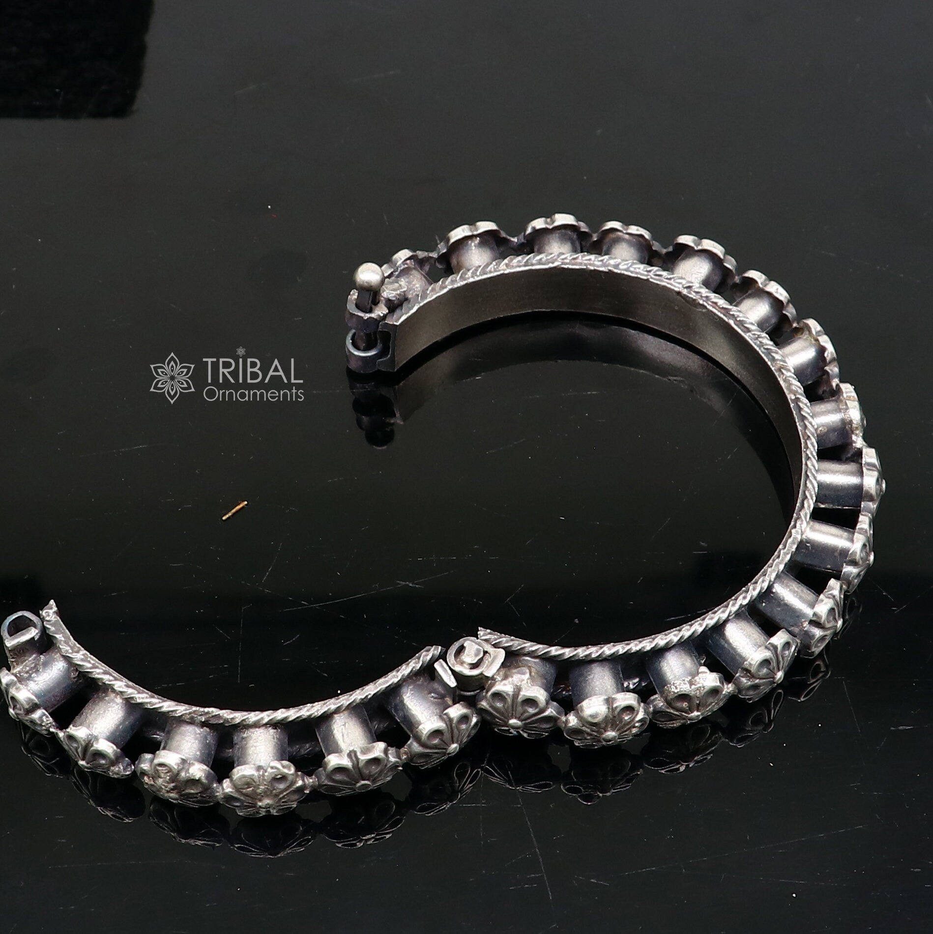 Sterling silver tribal floral bangle bracelet by TRIBAL ORNAMENTS, featuring intricate tribal design for brides and wedding jewelry.