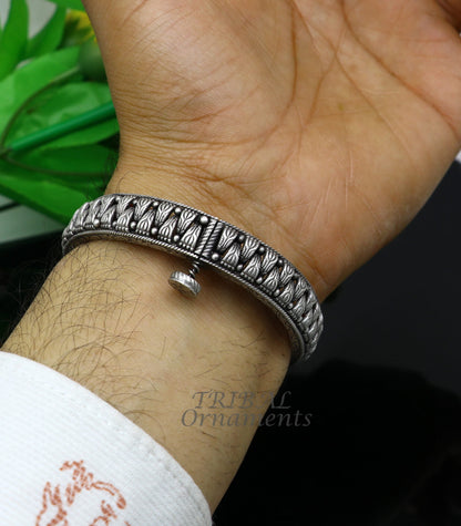 Vintage tribal 925 sterling silver bangle bracelet with ethnic design, showcasing intricate patterns in tribal jewelry style.