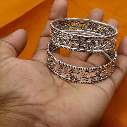 Sterling silver wide floral design bangle bracelet by TRIBAL ORNAMENTS, featuring intricate ethnic floral patterns and customized style.