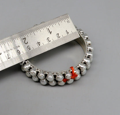 Sterling silver pearl bangle bracelet with oxidized finish, designed by TRIBAL ORNAMENTS, perfect for brides or elegant occasions.