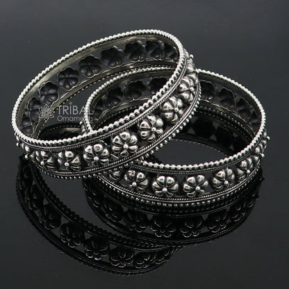 Sterling silver flower design bangle bracelet from TRIBAL ORNAMENTS, showcasing intricate handmade jewelry for brides and weddings.