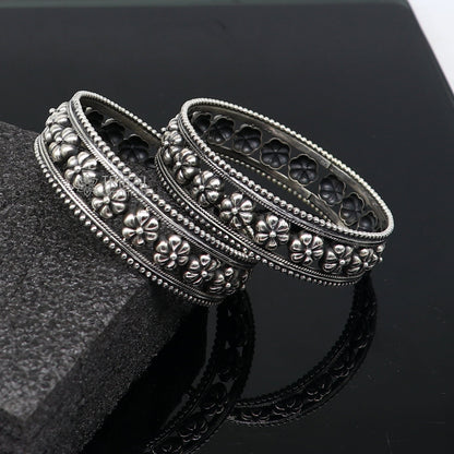 Sterling silver flower design bangle bracelet by TRIBAL ORNAMENTS, handmade wedding jewelry for brides, featuring intricate floral details.