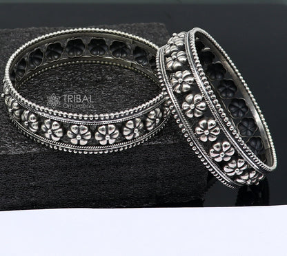 Sterling silver flower design bangle bracelet by TRIBAL ORNAMENTS, handmade wedding jewelry for brides, featuring intricate floral details.
