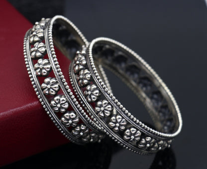 Sterling silver flower design bangle bracelet by TRIBAL ORNAMENTS, handmade wedding jewelry for brides, featuring intricate floral details.