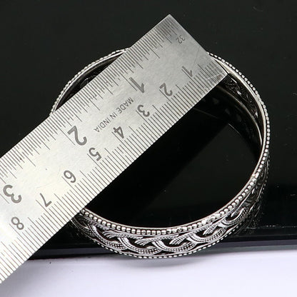 Sterling silver floral bangle bracelet by TRIBAL ORNAMENTS, featuring intricate tribal design, perfect for brides and special occasions.