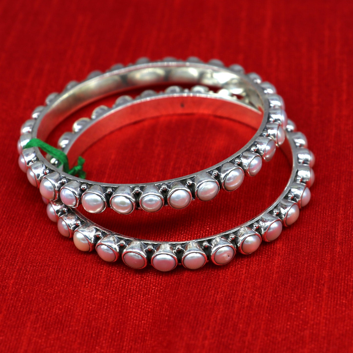 Sterling silver Waved design pearl bangle bracelet by TRIBAL ORNAMENTS featuring oxidized finish and custom bridal gift style.
