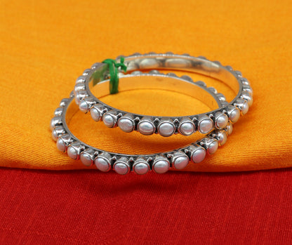 Sterling silver Waved design pearl bangle bracelet with oxidized finish, perfect for brides or special occasions.