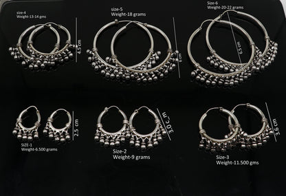 Sterling silver handmade hoop earrings by Tribal Ornaments, Bali-inspired tribal jewelry with silver hooks and intricate design.