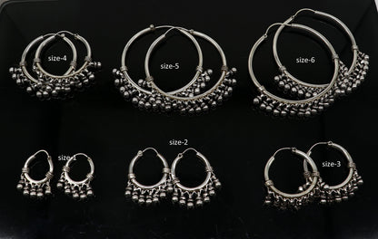 Sterling silver handmade hoop earring from TRIBAL ORNAMENTS, Bali-inspired tribal jewelry with silver hook and crafted details.