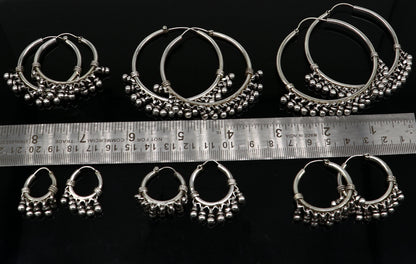 Sterling silver handmade hoop earring by Tribal Ornaments, Bali-inspired tribal jewelry with silver hook and intricate design.