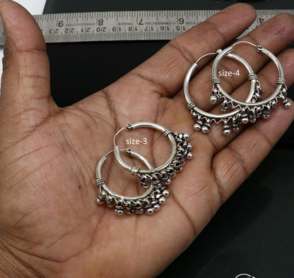 Handmade sterling silver hoop earring by TRIBAL ORNAMENTS, Bali-inspired tribal jewelry with silver hook, perfect for gifting.