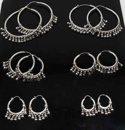 Sterling silver handmade hoop earring by TRIBAL ORNAMENTS, Bali-style tribal jewelry with silver hook, perfect for gifting.