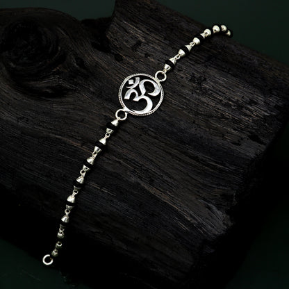 Sterling silver OM design Tulsi beads bracelet by TRIBAL ORNAMENTS, handmade with spiritual Aum symbols on a 6-7 inch bracelet.