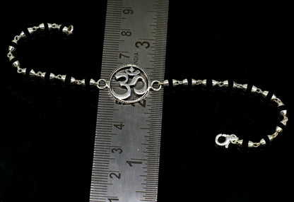 Sterling silver OM design Tulsi beads bracelet from TRIBAL ORNAMENTS, featuring spiritual Aum symbols and handmade craftsmanship.