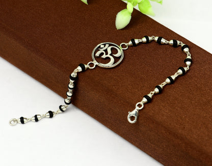 925 Sterling Silver OM design Tulsi beads bracelet with Aum motif, handmade spiritual jewelry from TRIBAL ORNAMENTS.