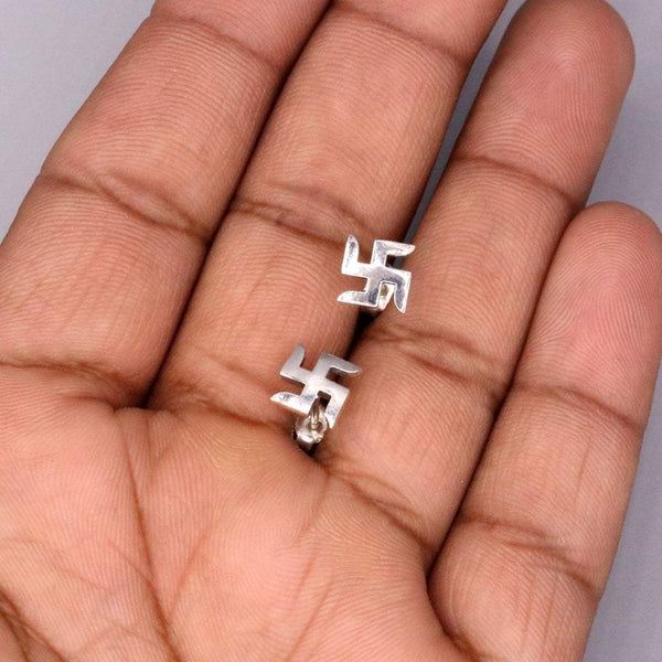 Sterling silver handmade swastika stud earring by TRIBAL ORNAMENTS, unisex Indian symbol jewelry with detailed design.