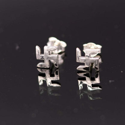 Sterling silver handmade swastika stud earring by TRIBAL ORNAMENTS, unisex Indian idol symbol jewelry, detailed and traditional design.