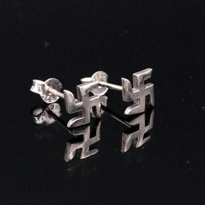 Sterling silver handmade swastika stud earring by Tribal Ornaments featuring Indian idol symbol, unisex jewelry design.