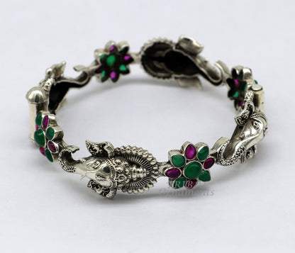 Sterling silver Ganesha bangle bracelet with floral red and green stones, ethnic jewelry by TRIBALORNAMENT.