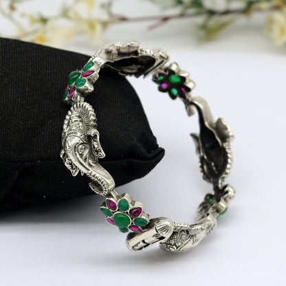 Sterling silver Ganesha design bangle bracelet with floral red and green stones, ethnic jewelry by TRIBALORNAMENT.