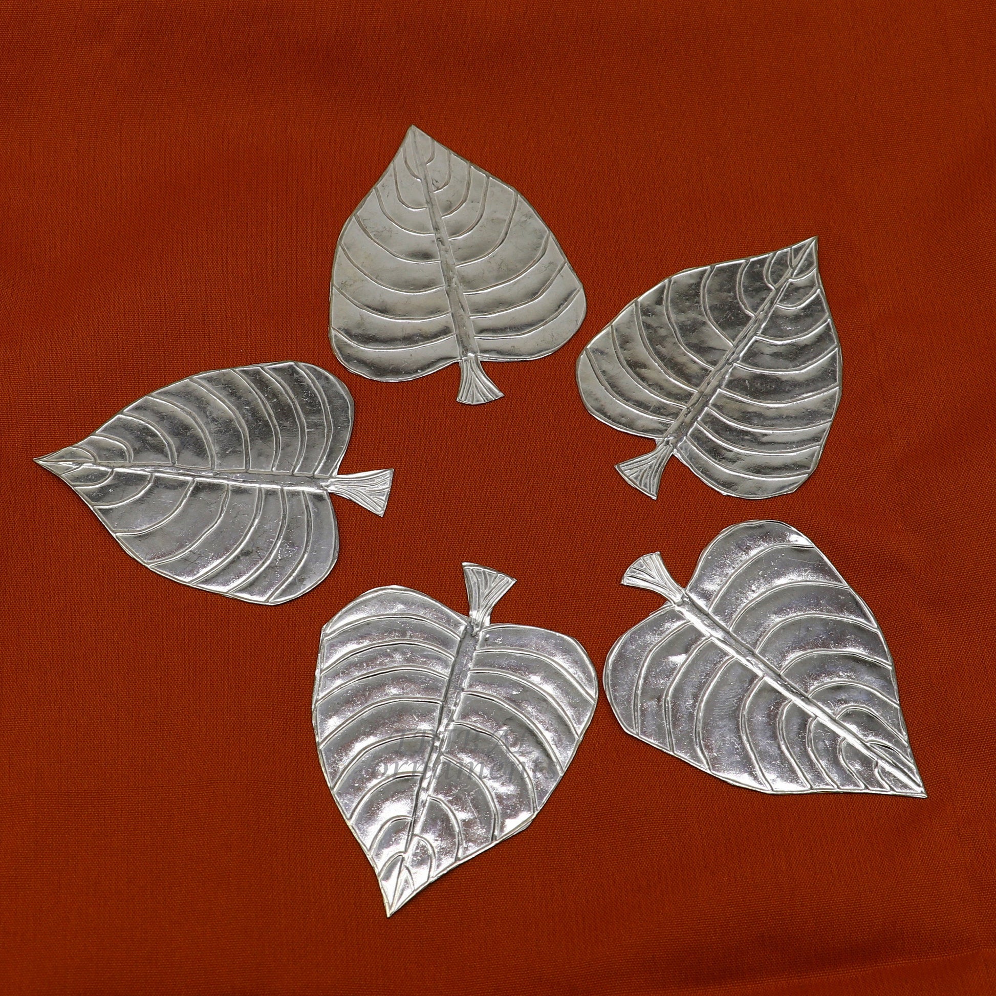 Set of 5 handmade 925 sterling silver pipal leaf puja articles by TribalOrnaments, showcasing detailed silver craftsmanship.