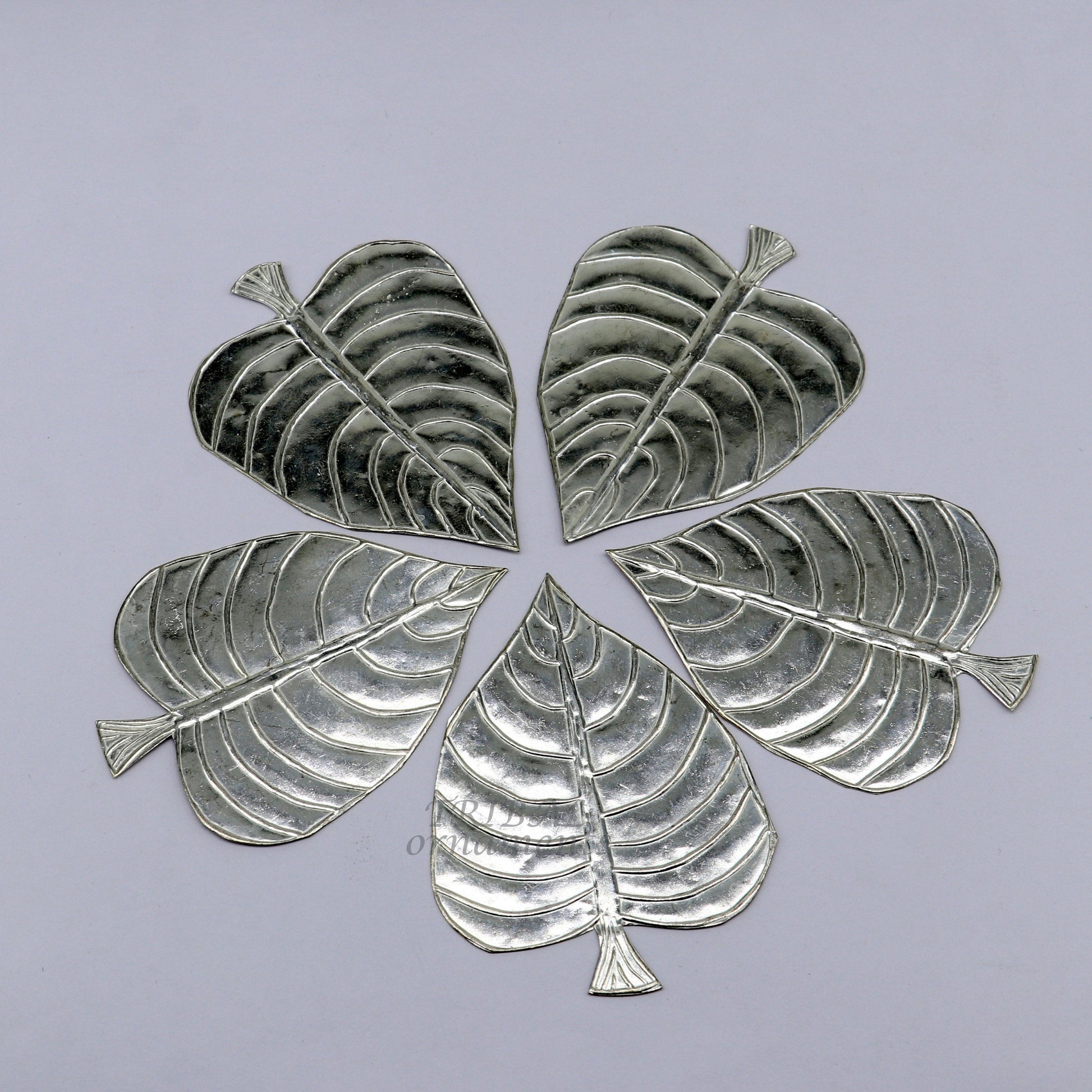 Set of 5 handmade 925 sterling silver pipal leaf puja articles by TribalOrnaments, featuring detailed silver craftsmanship.